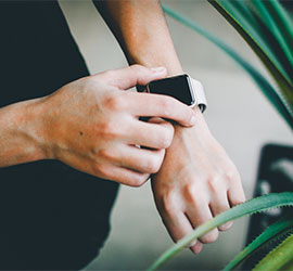 Close-up of someone checking the time on a smartwatch