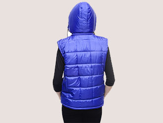 Back view of a person wearing a blue padded gilet with hood