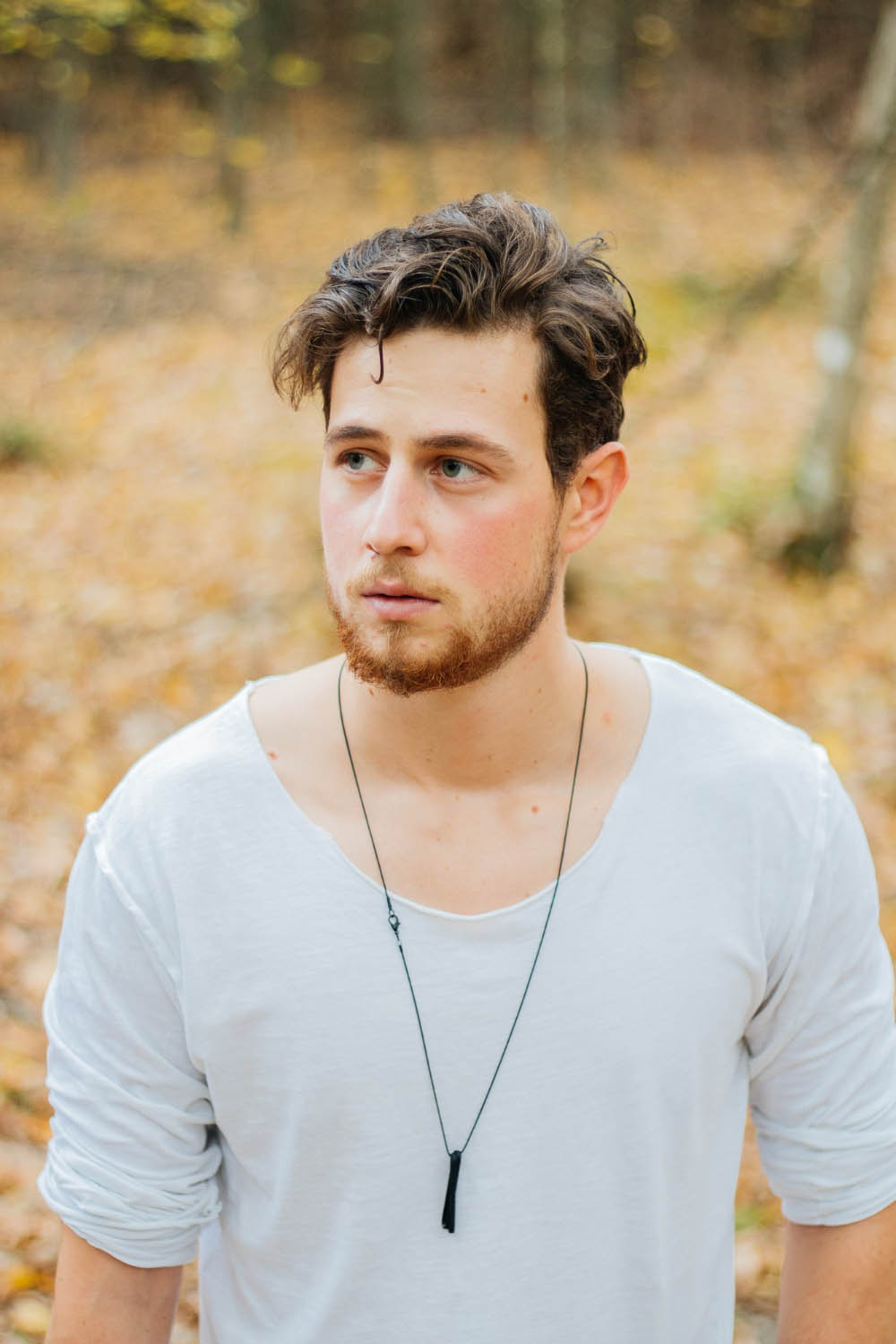 Image of young handsome guy in autumn park