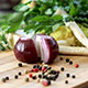 Red onion and vegetables on a chopping board