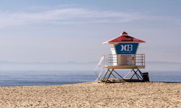 Lifeguard tower on a quiet sandy beach with ocean in the background