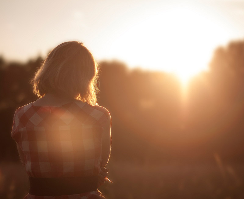 Image of woman viewing sunset