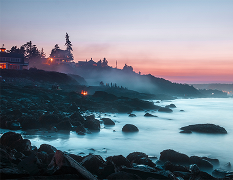 Rocky coastline at dusk with waves