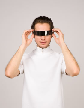 Young man wearing futuristic AR visor and white high-neck shirt against plain background adjusting the device.
