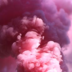 Dense pink and purple smoke billowing in thick clouds creating a surreal and dramatic visual effect.