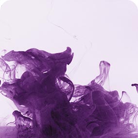 Abstract purple ink swirling and diffusing in clear water with light background creating fluid shapes and textures