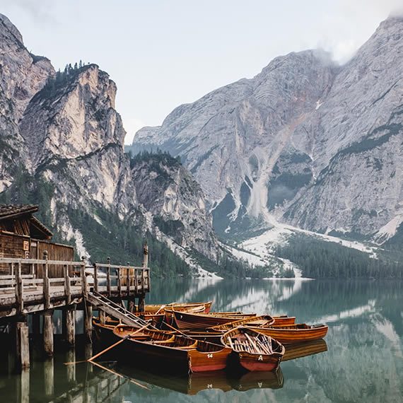 Image of glacial lake with pier and boats