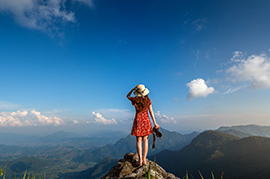 Image of woman on mountain peak