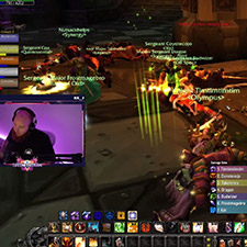 Intense multiplayer battle scene from a fantasy MMORPG with numerous players and vibrant spell effects in a dungeon environment.